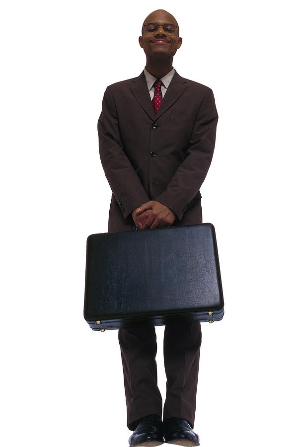 Businessman posing with briefcase Photograph by Comstock