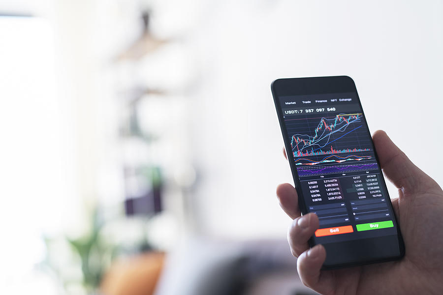 Businessman reading financial stock market analysis on smartphone. Photograph by ArtistGNDphotography Businessman reading financial stock market analysis on smartphone. Photograph by ArtistGNDphotography