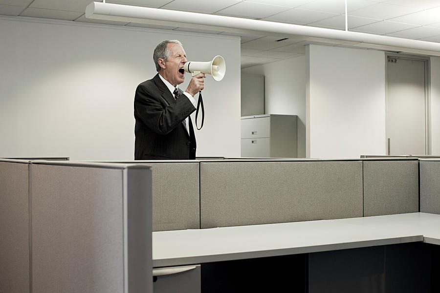 Businessman shouting through megaphone Photograph by Image Source