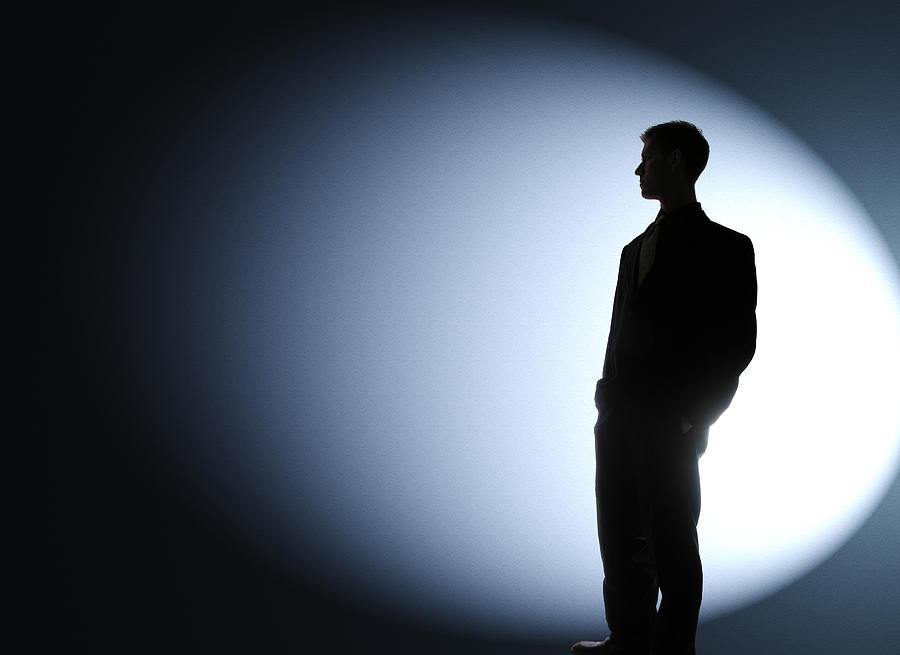 Businessman silhouetted in a spotlight Photograph by Joshblake
