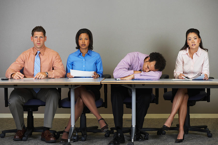 Businessman sleeping during a meeting Photograph by Image Source