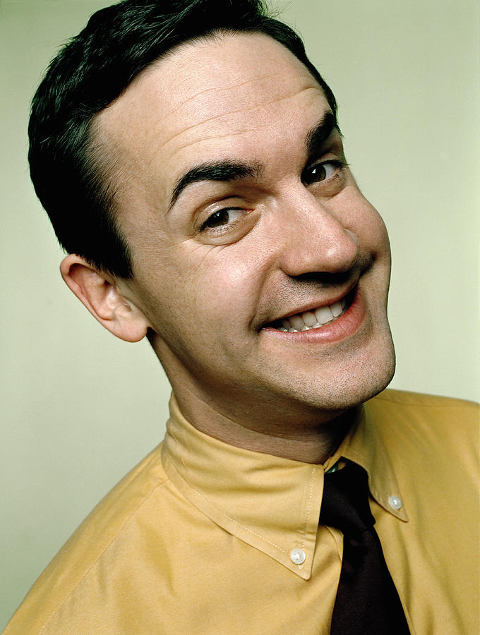 Businessman smiling, close-up, portrait Photograph by Andreas Kuehn