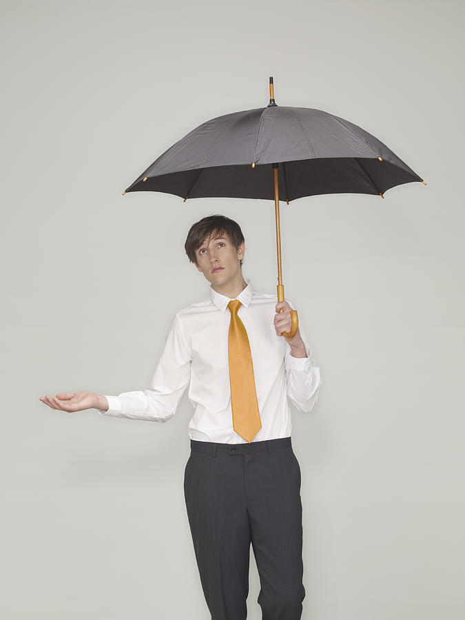 Businessman Standing Under An Umbrella  Photograph by Oppenheim Bernhard
