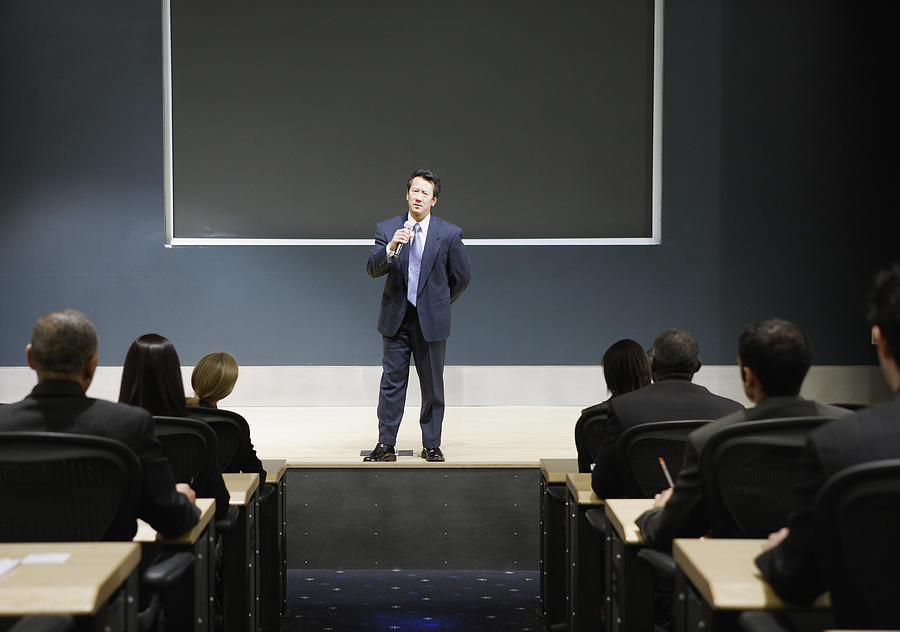 Businessman talking in auditorium Photograph by Andersen Ross Photography Inc