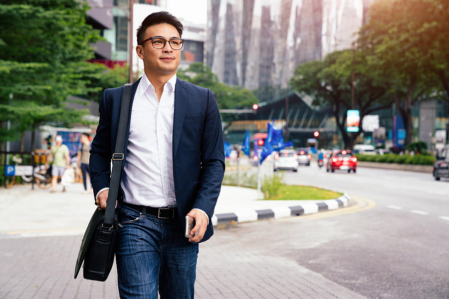 Businessman walking in Downtown Kuala Lumpur Malaysia Photograph by Mlenny