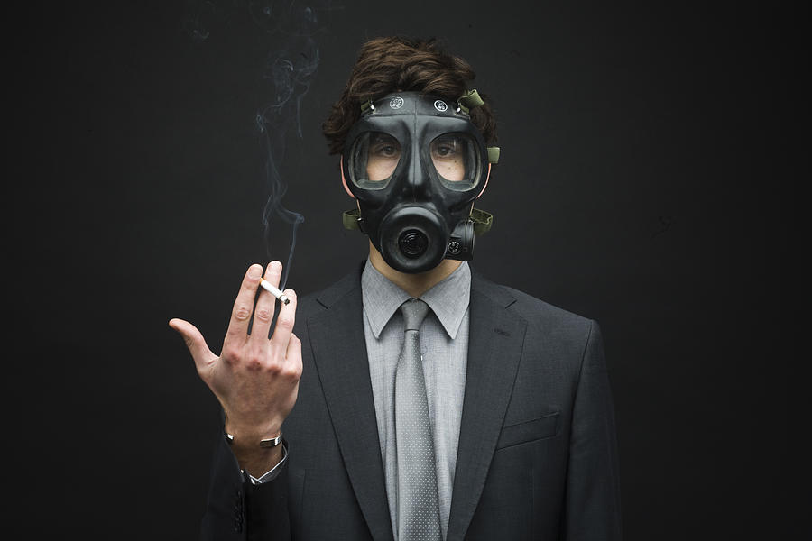 Businessman Wearing Gas Mask and Smoking Cigarette Photograph by Sidneybernstein