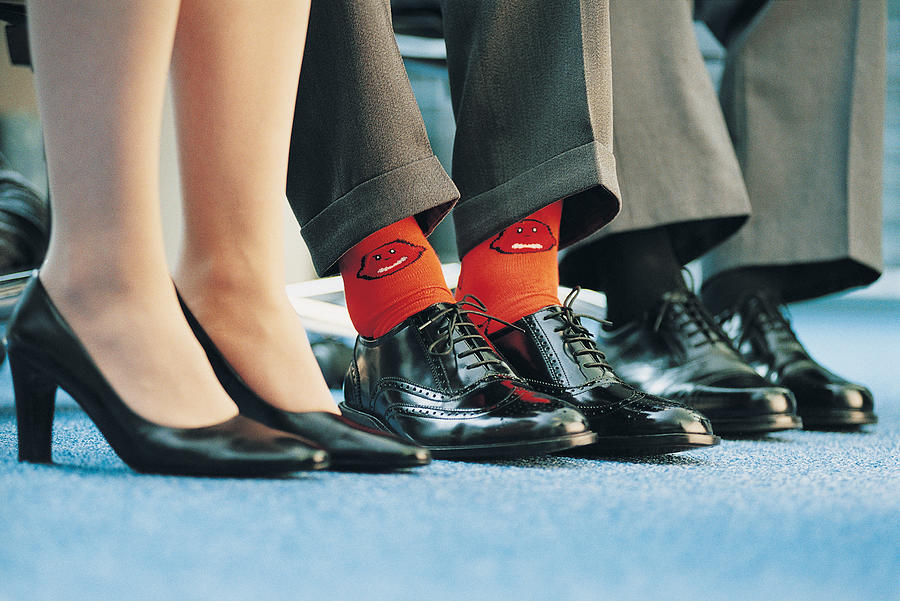 Businessman Wearing Individualistic Socks Between Two of His Colleagues Photograph by Flying Colours Ltd