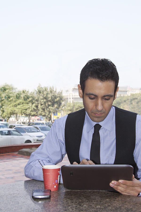 Businessman with a digital tablet , INDIA , DELHI Photograph by Sudipta Halder