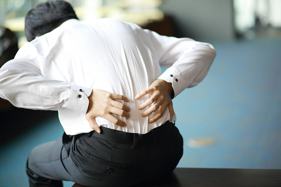 Businessman with  backache Photograph by RunPhoto