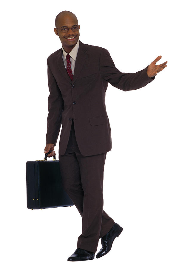 Businessman with briefcase walking Photograph by Comstock