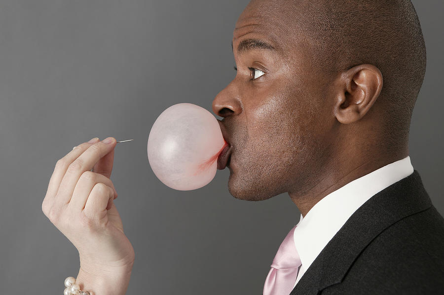 Businessman with bubble gum bubble about to be popped Photograph by Comstock Images
