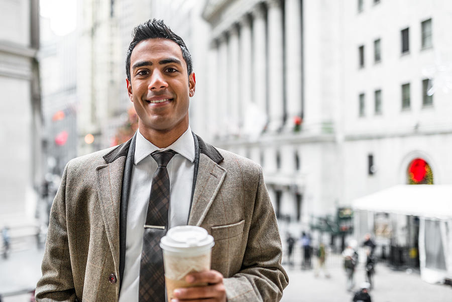 Businessman with coffee mug on wall street Photograph by Franckreporter