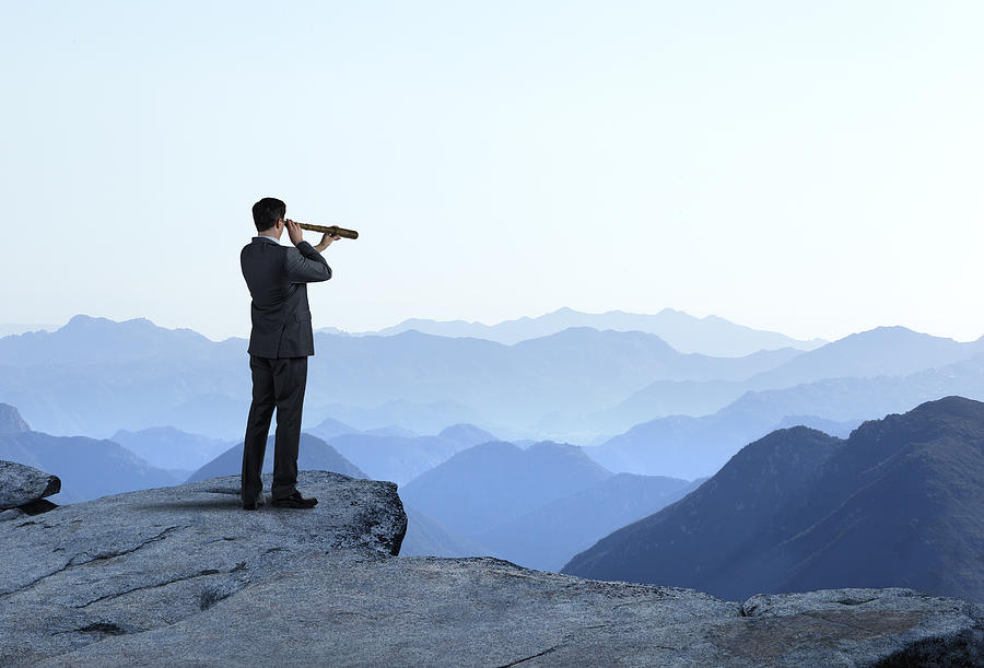 Businessman With Spyglass Looking Out Toward Mountain Range Photograph by Dny59