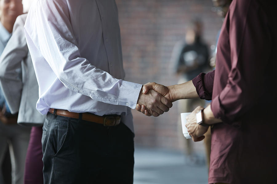 Businessmen making handshake at conference Photograph by Klaus Vedfelt
