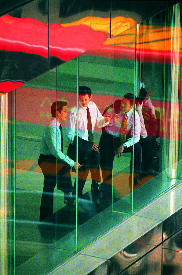 Businessmen seen through window Photograph by Photodisc
