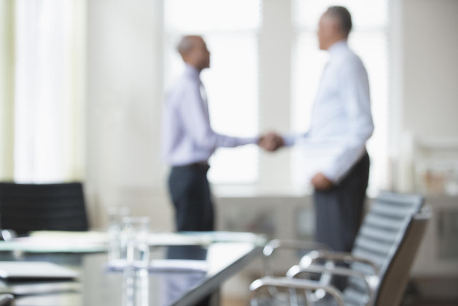 Businessmen shaking hands office meeting Photograph by Jose Luis Pelaez Inc