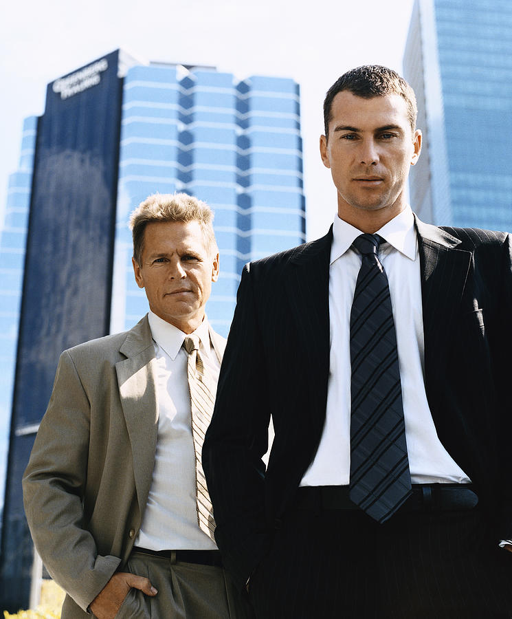 Businessmen Standing Outdoors in a City Wearing Full Suits Photograph by Digital Vision.