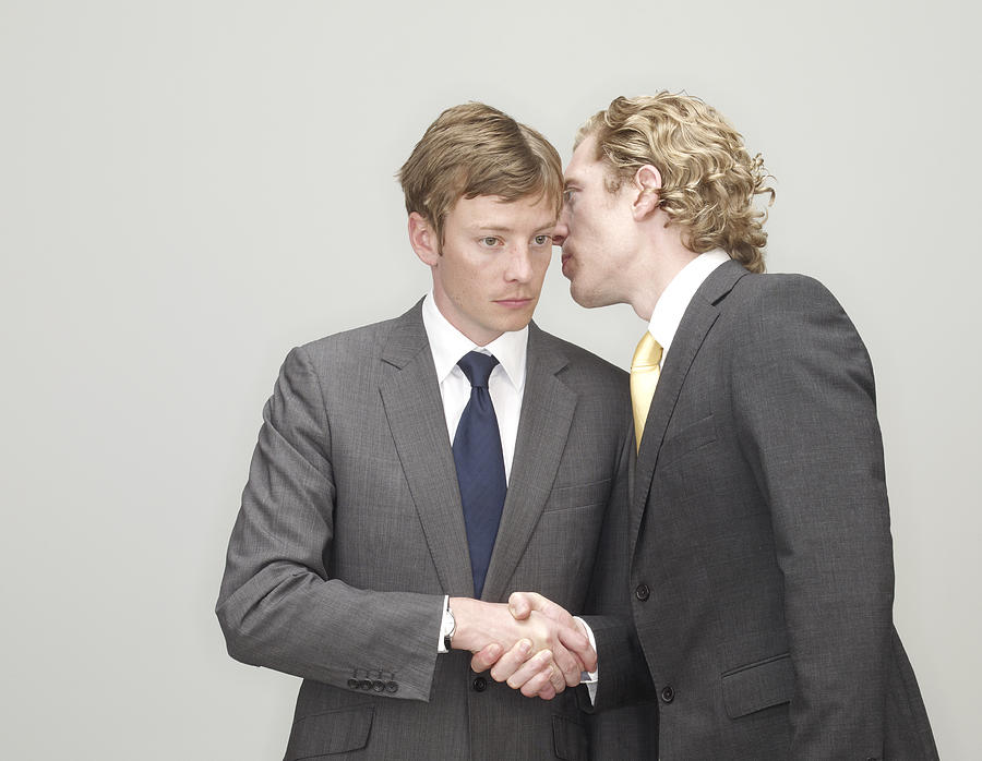 Businessmen Whispering And Shaking Hands Photograph by Oppenheim Bernhard