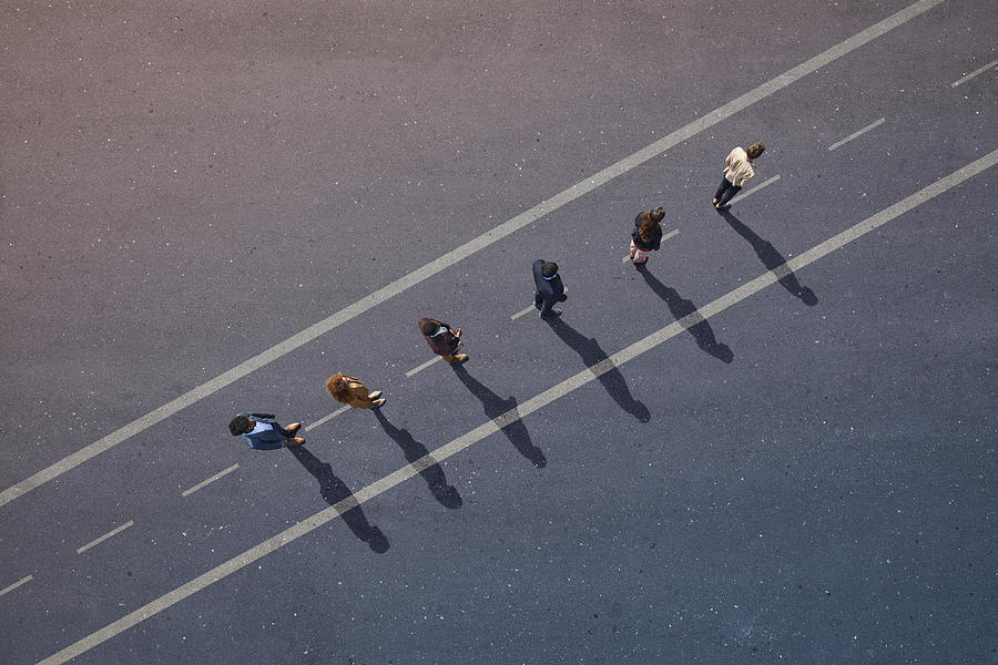 Businesspeople standing in line across road painted on asphalt Photograph by Klaus Vedfelt