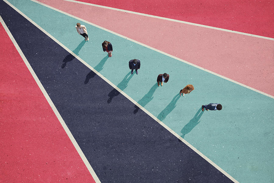Businesspeople standing in line on bright coloured asphalt Photograph by Klaus Vedfelt