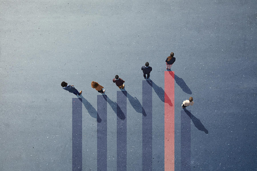 Businesspeople standing on painted bar chart graph on asphalt Photograph by Klaus Vedfelt