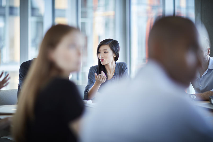 Businesswoman gesturing in meeting Photograph by Caia Image