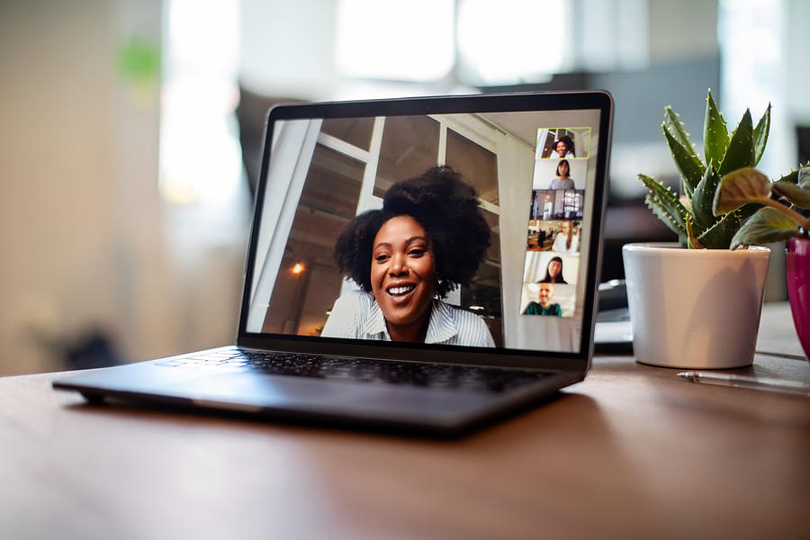 Businesswoman having a video call meeting with her team Photograph by Luis Alvarez