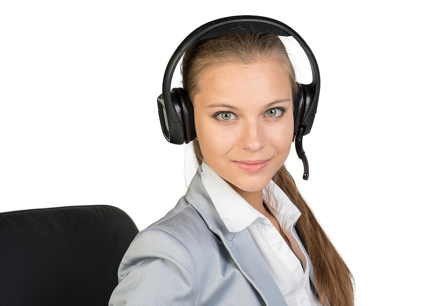 Businesswoman in headset sitting on chair Photograph by Cherezoff