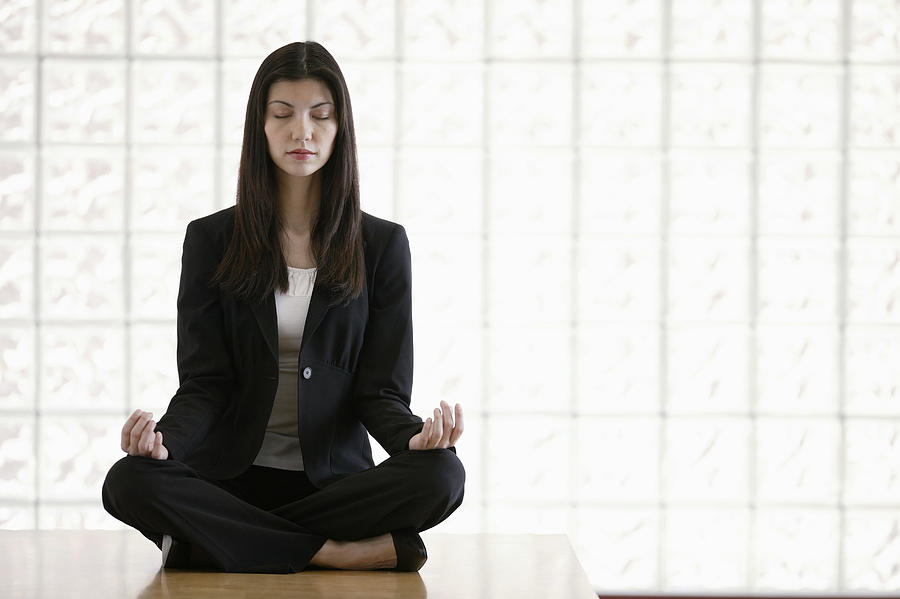 Businesswoman meditating Photograph by Comstock Images