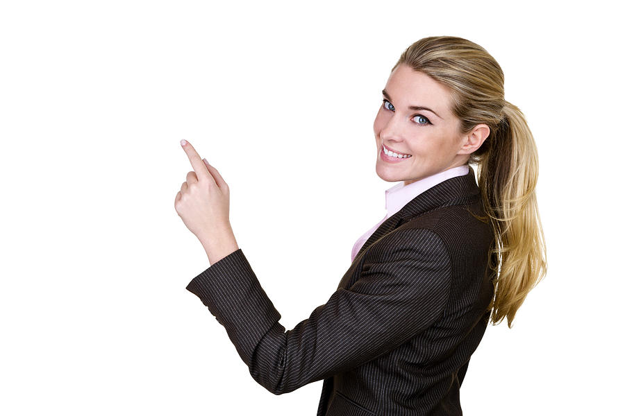 Businesswoman pointing to copy space Photograph by Stockphoto4u