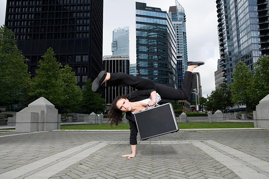 Businesswoman practising capoeira Photograph by Image Source
