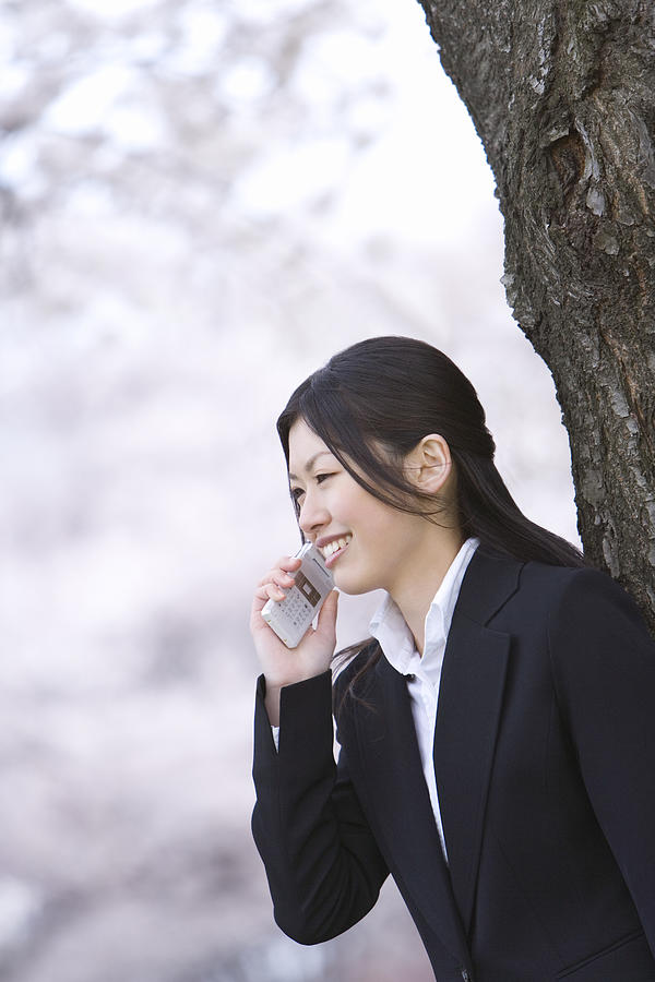 Businesswoman Talking on Mobile Phone, Waist Up, Side View, Differential Focus Photograph by Daj