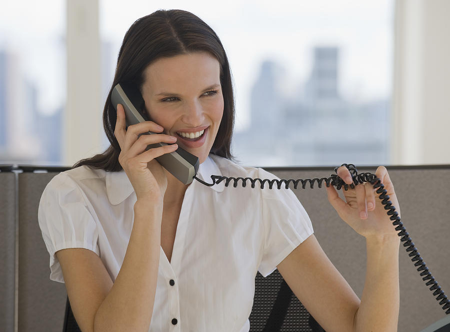 Businesswoman talking on telephone Photograph by Tetra Images