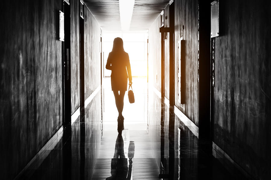Businesswoman through the office corridor Photograph by Baona