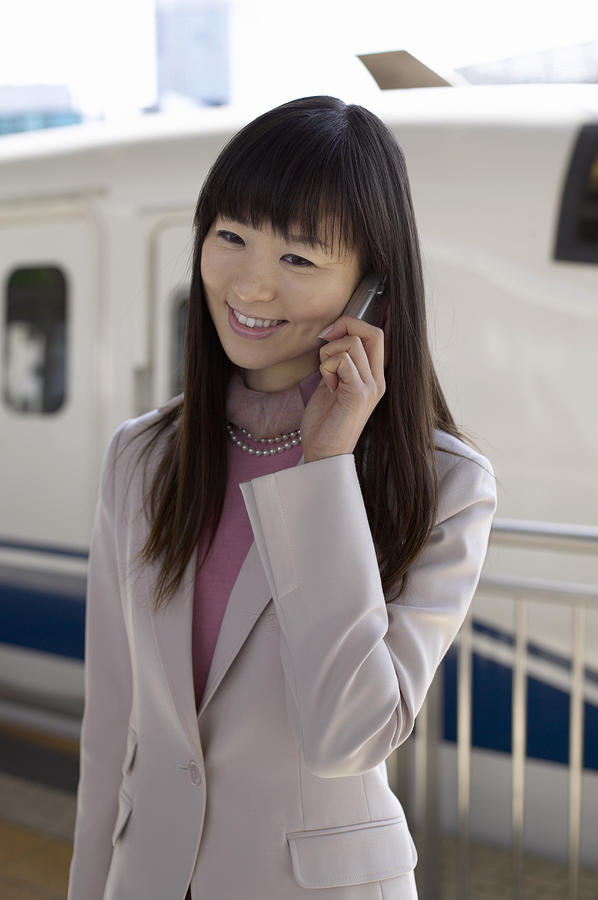 Businesswoman Using a Mobile Phone Photograph by Digital Vision.