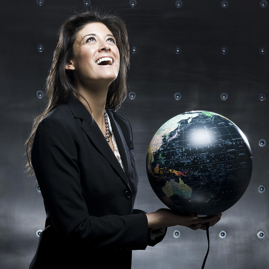 Businesswoman With A Globe In Her Hands Photograph by RubberBall Productions