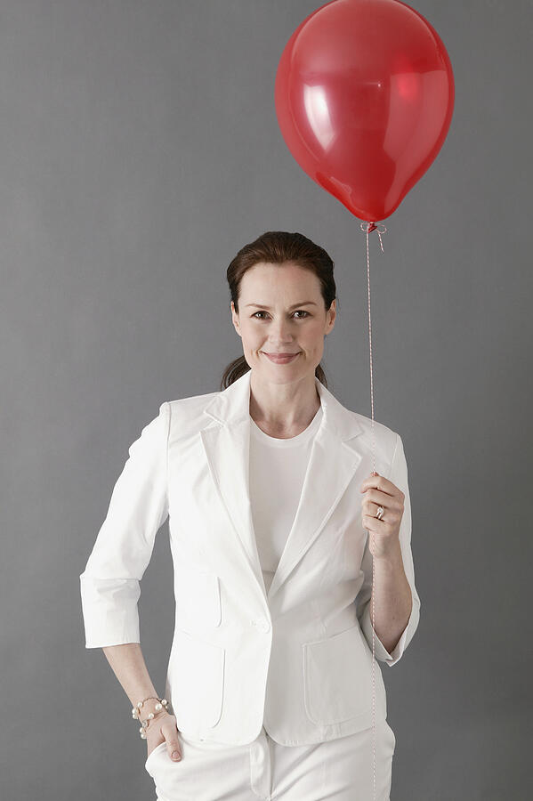 Businesswoman with balloon Photograph by Comstock Images