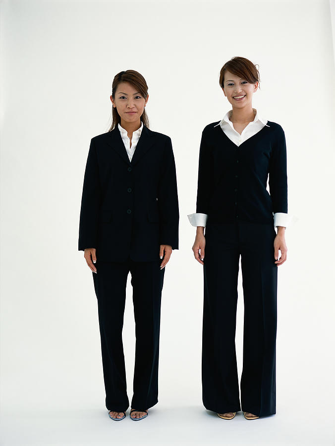 Businesswomen standing, smiling, portrait Photograph by Hitoshi Nishimura