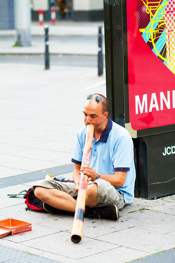 Busker playing didgeridoo Photograph by Justhavealook