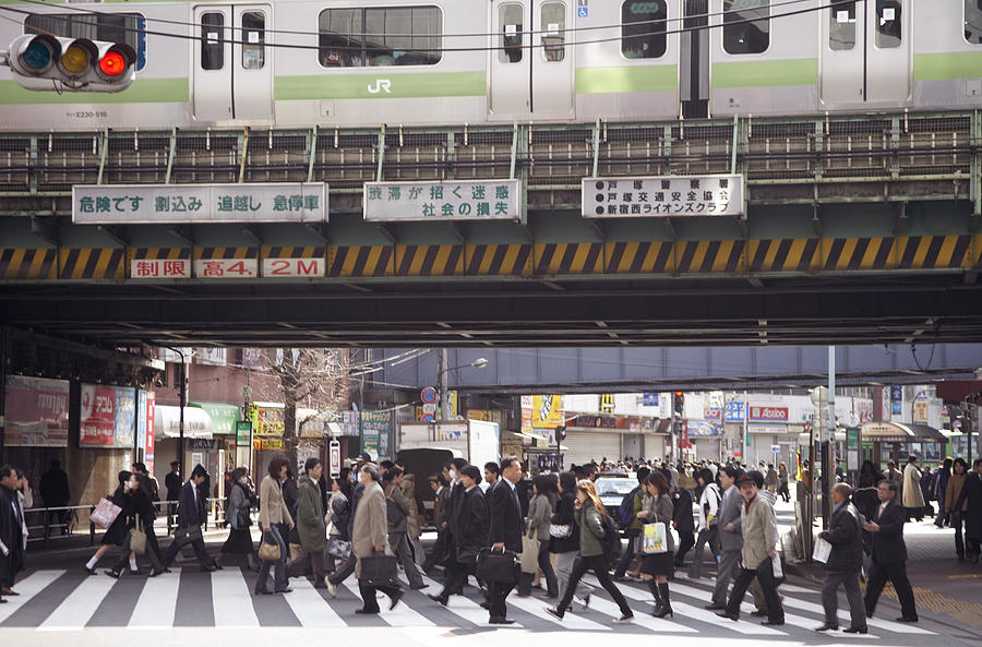 Busy Pedestrian Crossing Underneath a Railway Bridge, Japan Photograph by Digital Vision.