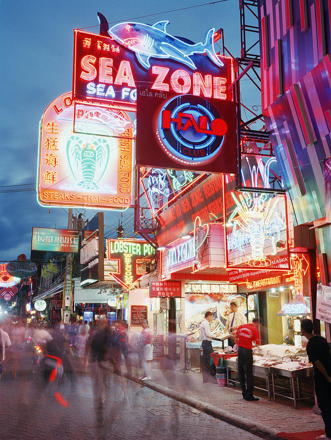 Busy street lit with neon signs Photograph by Gary Yeowell