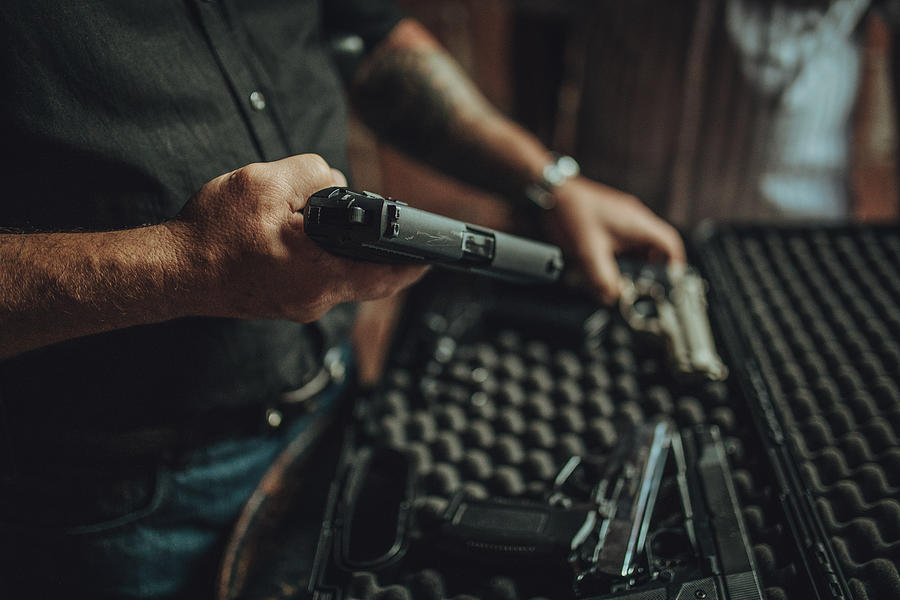 Buying a gun on black market Photograph by South_agency