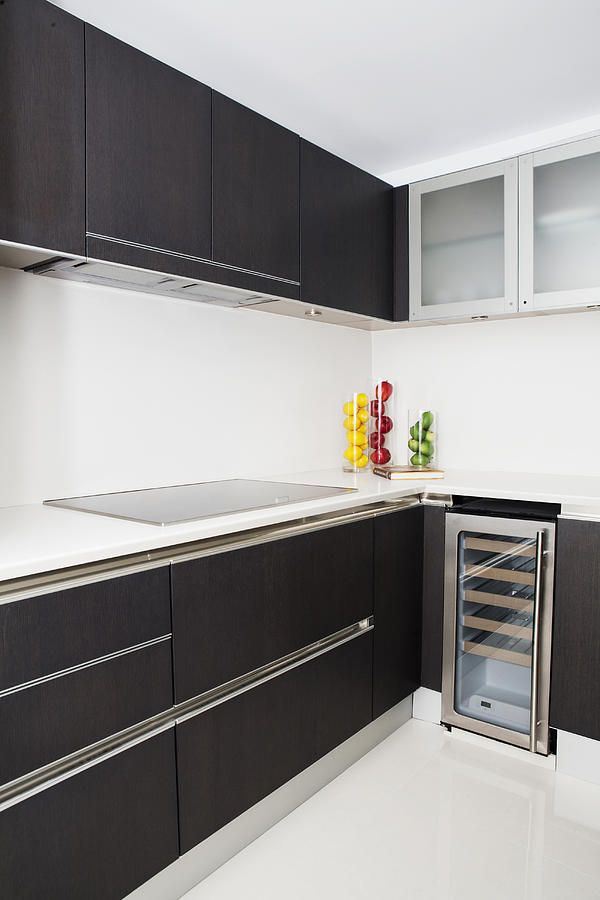 Cabinets, stove and miniature refrigerator in modern kitchen Photograph by Camilo Morales