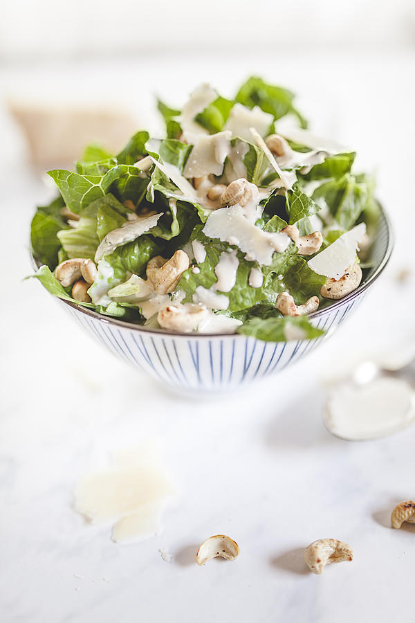 Caesar Salad with roasted cashews in a bowl Photograph by Westend61