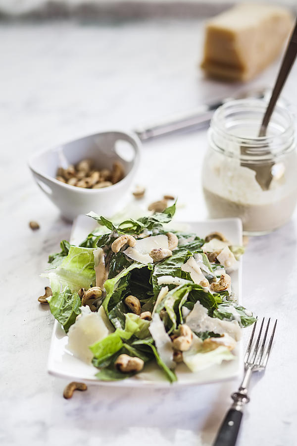 Caesar Salad with roasted cashews on plate Photograph by Westend61