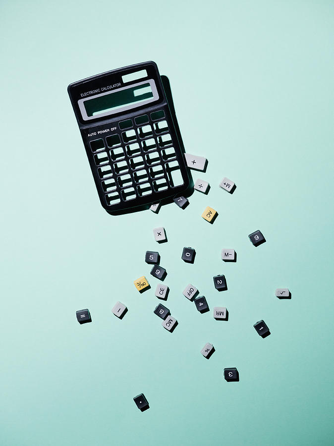 Calculator with broken buttons over blue background Photograph by Larry Washburn