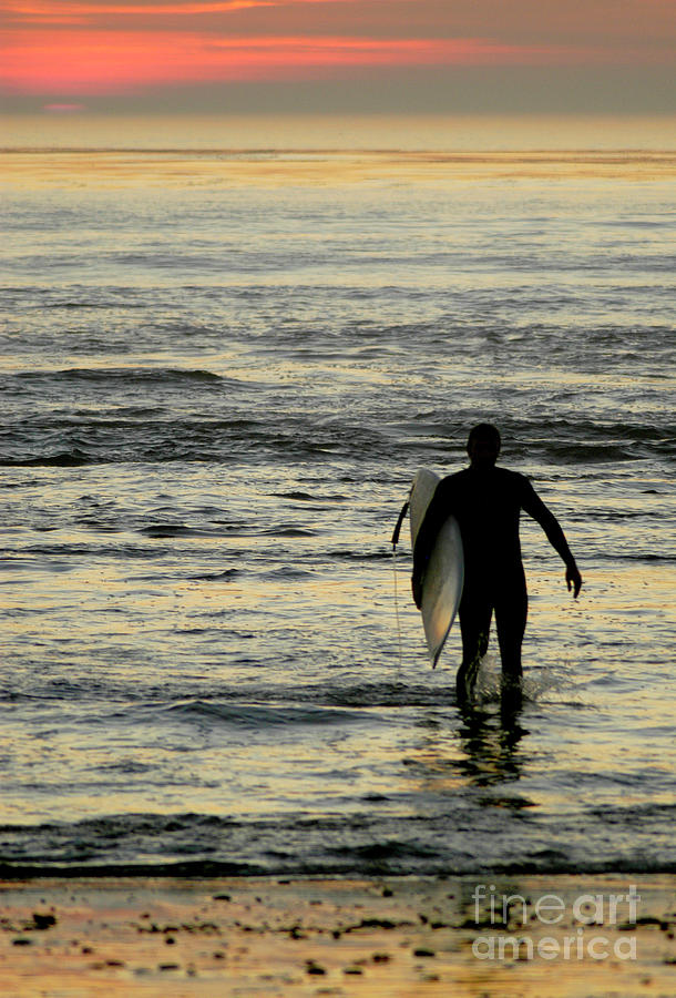 California surfer heading out for a last wave at sunset. Photograph by Gunther Allen