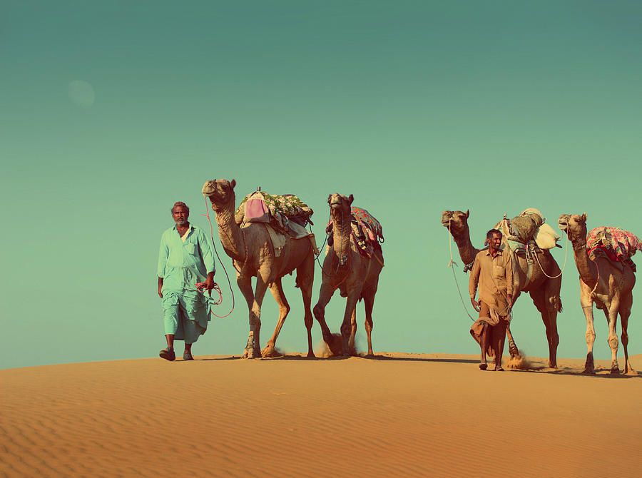 Cameleers With Camels In Desert  - Vintage Retro Style Photograph by Mikhail Kokhanchikov