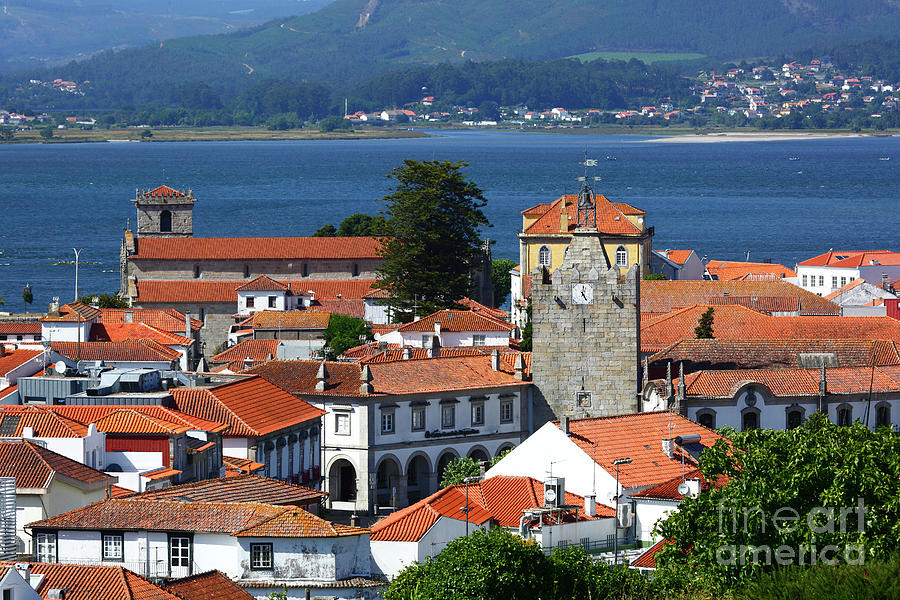 Caminha clock tower and rooftops Portugal Photograph by James Brunker