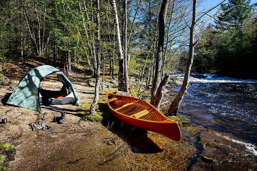 Camping at the riverbank with a canoe Photograph by Max shen